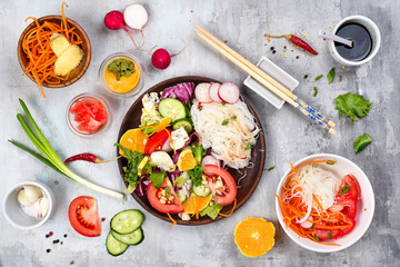 Spicy glass noodles with vegetables - carrots, cucumber, peppers, garlic.