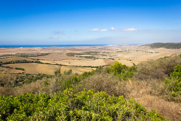 Scenic views of open land and coast from hill viewpoint in Cadiz province, Spain