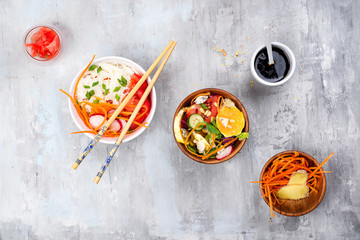 Asian spicy salad of glass noodles or funchoza with carrots and vegetables salad on stone background