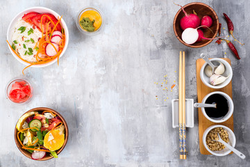 Asian spicy salad of glass noodles or funchoza with carrots and vegetables salad on stone background