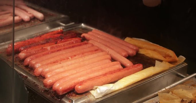 Sausages on plate grill in 4K