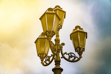 Fototapeta na wymiar Ancient street lamp on the sky background
