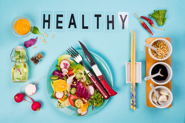 Healthy eating concept with fresh vegetables and salad bowls on kitchen wstone worktop,