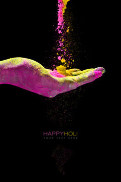 Hand holding colorful powder for holi festival of colors