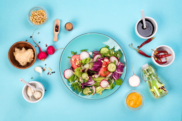 Healthy eating concept with fresh vegetables and salad bowls on kitchen wstone worktop,