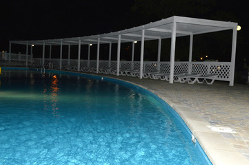 Sun loungers by the pool at the hotel on a seaside holiday.