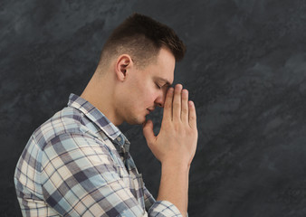 Portrait of hopeful man praying, headshot