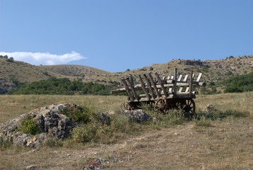 Abandoned wagon in the background of mountains