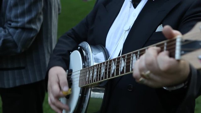 man playing black guitar detail wedding