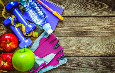 Fitness concept with dumbbells and fresh fruits