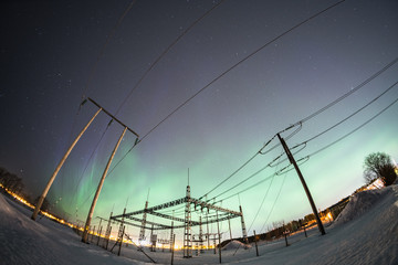 outdoor electrical switchgear at winter night with aurora borealis northern lights sweden snow field fisheye lenses