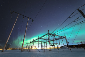outdoor electrical switchgear at winter night with aurora borealis northern lights sweden snow field