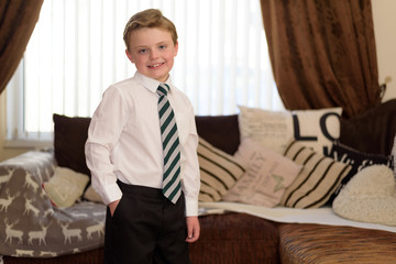 Young boy dressed in new uniform and ready for school