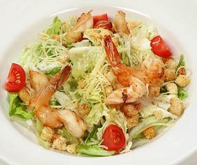 Caesar salad with tiger shrimps, salad mix, tomatoes, parmesan cheese