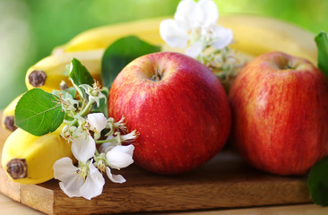 apples and  bananas on green background