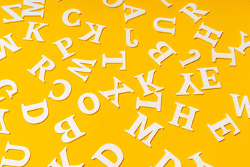 White letters on a yellow background. Letters. English alphabet.