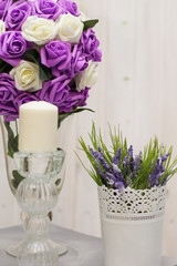 lilac flowers in a vase and candles on the candle holders for a romantic atmosphere