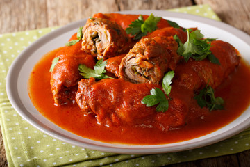 Delicious beef steak stuffed with parsley and parmesan cheese stewed in tomato sauce close-up. horizontal