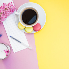 Creative flat lay with coffee cup and macaroons
