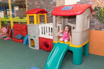 Fototapeta na wymiar child is playing on the playground indoors