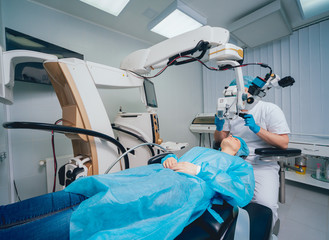 Eye surgery. A patient and surgeon in the operating room during ophthalmic surgery. Vision...