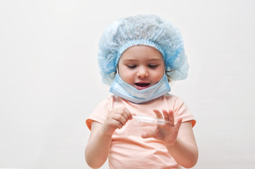 Adorable little girl playing at the doctor