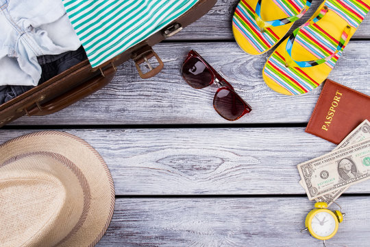 Summer clothes and accessories on wood. Resort vacation attributes flat lay.