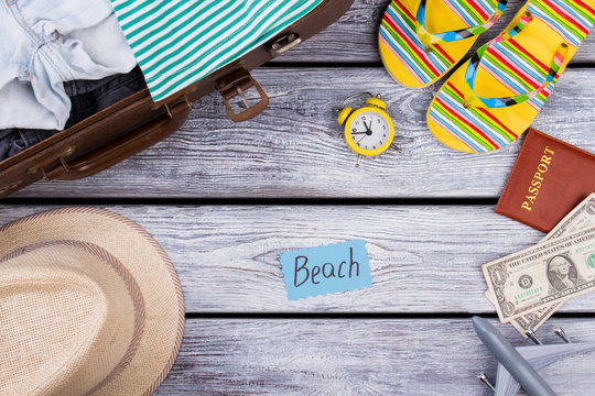 Beach items concept flat lay. Wooden desk surface background.