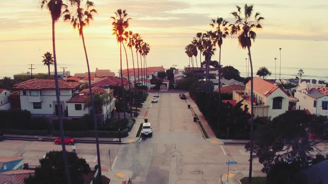 Aerial view of California beach city and palm trees at sunset