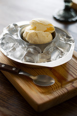 Homemade caramel sundae with white chocolate and parmesan in a plate with ice.