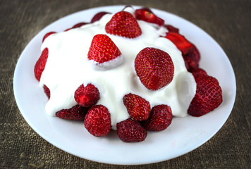 fresh strawberry with cream close-up.