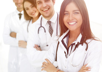 female doctor with group of happy successful colleagues