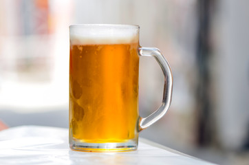 Cold weiss beer in glass with bokeh background