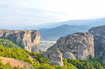 Fototapeta na wymiar Greee, Meteora. Stunning spring panoramic landscape. View at mountains and green forest. Unesco heritage list object.