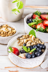Bowl of natural yogurt with granola and fresh berries