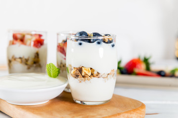 Little Jars with layered dessert from natural yogurt, granola an