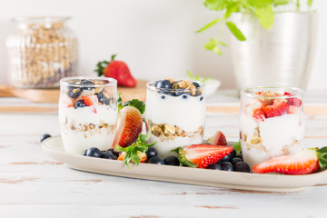 Little Jars with layered dessert from natural yogurt, granola an