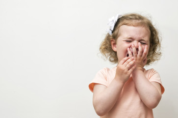 Girl crying over white background