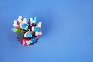 Toothbrushes in a glass on blue background