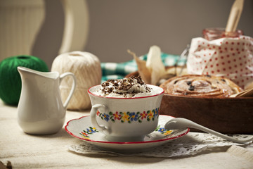 Coffee with cream and Danish pastry on the table