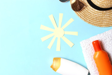 sunscreen, towel, hat, glasses on a colored background. Cosmetics for safe sunburn. top view, flatlay 