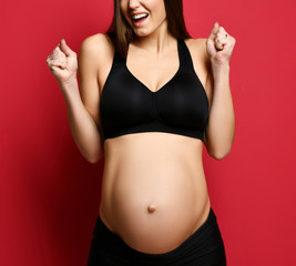 Young pregnant happy mother woman happy smiling on red