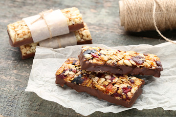 Tasty granola bars on wooden table