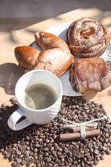 still life of coffee breakfast with brioches on a wooden background