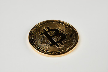 Golden bitcoin isolated on white background. Cryptocurrency coin, close-up