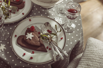 Table for two with  chocolate biscuits and red wine