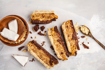 Coconut-oat raw vegan bars. Top view, light background, copy space. Healthy vegan food concept.