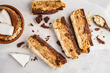 Coconut-oat raw vegan bars. Top view, light background, copy space. Healthy vegan food concept.
