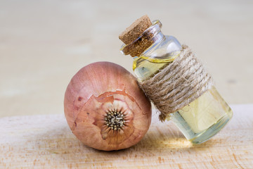 Syrup of onion in a small vial on a wooden table. Flu medicine in a small glass container.