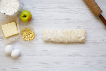 Raw apple pie or strudel with ingredients, top view. Flat lay. Copy space.